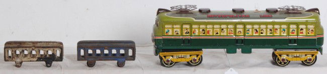 Mlien tin passenger train, two cast iron train flo: Mlien Japanese tinplate battery operated, electric passenger train, missing battery compartment door and two cast iron train floor toys. Please view the photographs for the best description and as to