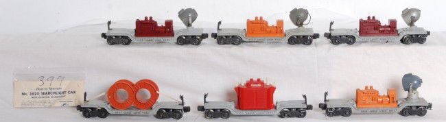 Three Lionel No. 6520, 3620, 2461, 6561: Postwar Lionel O gauge No. 3620 and three 6520 searchlight cars, 2461 transformer car and 6561 depressed center flatcar with two cable reels. Trains look C6 area. Transformer car appears to have all o