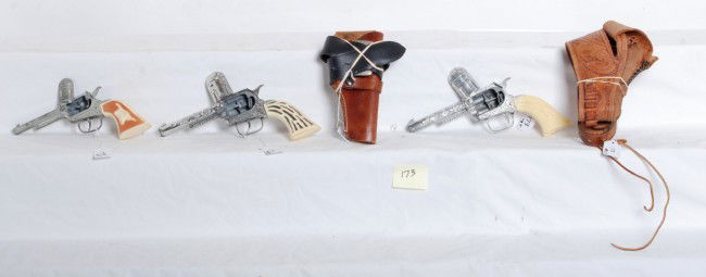 Two Pony Boy vintage toy cap guns and two holsters: Two older vintage Pony Boy cap guns and a Gabriel, all are unfired C7-8. One older has foliage motifs, single gun and belt rig. Other is a childÕs belt and a real unmarked holster for small gun.