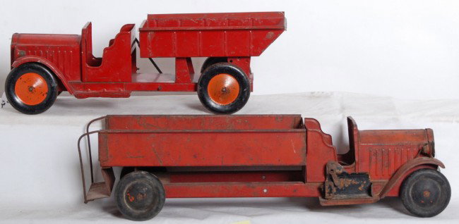 Structo trucks, dump and fire? older 1920Õs-1930Õs: Two Structo pressed steel trucks with battery powered head lights. Trucks appear to be in original paint. Dump truck has mechanical Please view the photographs for the best description and as to the c