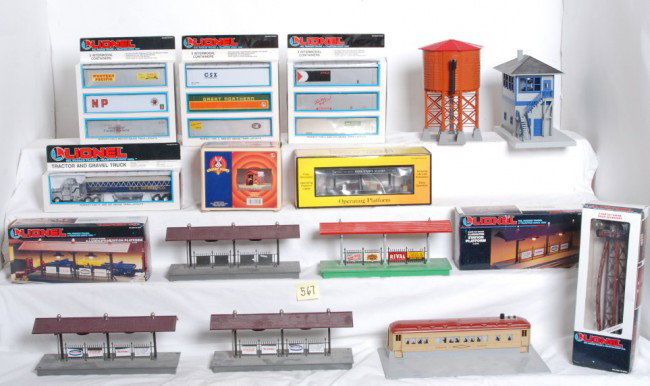 Group of MTH / Lionel track side accessories: Large group of modern O Gauge track side accessories. MTH accessories include Railking switch tower and 30-9111 operating freight platform. Lionel accessories include diner with smoke, modern #30 wate