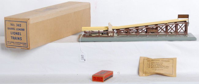 Lionel No. 362 barrel loader in OB, w/insert.... M: Postwar Lionel O gauge No. 362 barrel loader in original box with insert, inspection slip, complete components envelope and 362-78 six barrels OB with barrels. Box has OPS price penciled out. Loader i