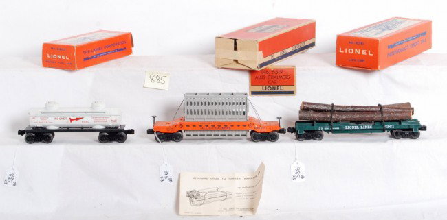 Lionel No. 6519, 6361 and 6463 in OB: Postwar Lionel O gauge No. 6519 Allis Chalmers car (good brake stand mounts), 6361 log car with instructions sheet and 6463 rocket fuel car, in original boxes. Trains are unrun C9 area. Boxes have mis