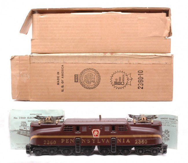 Lionel 2360 Tuscan Pennsylvania GG1 Boxed: Lionel postwar 2360 Tuscan Pennsylvania GG1 electric loco that has a solid stripe and heat stamped lettering in OB with original cardboard insert and instruction sheets. The loco has some paint touch