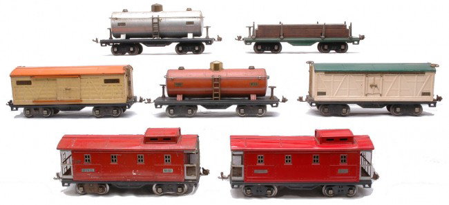Lionel Freights 511 514 514 515 515 517 517: Lionel prewar standard gauge freight cars including; 511 peacock flatcar with wood load, nickel trim and copper journals, 514 cream boxcar with an orange roof, brass trim and nickel journals, 514 ivor