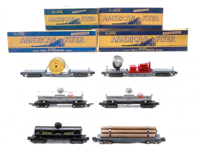 Am Flyer Freights 928 936 946 24321 625G 925: American Flyer S gauge freight cars including; 628 C. & N. W.RY flatcar with six wooden logs and conversion knuckle couplers, 936 Erie depressed center reel car, 946 Erie floodlight car with a red gen