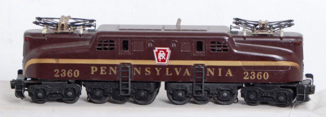 Lionel No. 2360 PRR solid stripe Tuscan GG-1: Postwar Lionel O gauge No. 2360 Pennsylvania solid stripe Tuscan GG-1, electric locomotive, C6+. Train has a tiny touchup that looks factory.