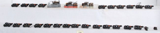 Box of postwar Lionel truck assemblies, whistles: Box of twenty-four postwar Lionel O gauge staple end and bar end trucks with couplers, pickup rollers, slide shoes, and some pieces (a couple could be missing some thing). Three whistles, two with pla