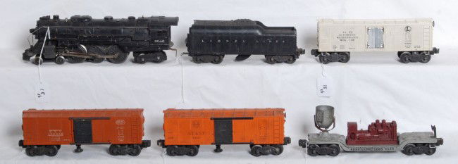 Lionel No. 2046, whistle tender, 3472, 3464, 6520: Postwar Lionel O gauge NO. 2046 loco, tender with whistle, 3472 milk reefer, two 3464 op. boxcars and 6520 searchlight car. Please view the photographs for the best description and as to the condition