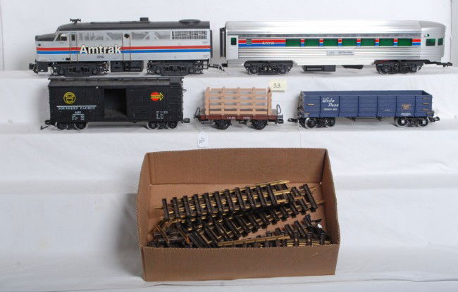 LGB Amtrak diesel, SP b.c., White Pass, Amtrak OBs.: LGB G scale Amtrak diesel No. 2036, L.G.&B. flatcar with sides 94061, Southern Pacific boxcar No. 1955, White Pass gondola 207, Amtrak 2406 Metro Park aluminum passenger car. Some various lengths of c