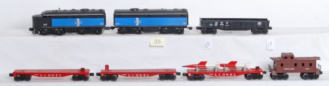Lionel No. 217, 6823, 6826, 6819, 6062, 6017: Postwar Lionel O gauge No. 217 Boston and Maine Alco A-B units, 6823 flatcar with rockets, 6826 flat, 6819 flat, 6062 NYC gondola and 6017 caboose, trains look C7-8. Locos have some light rust on fram