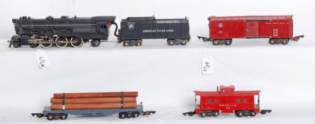 American Flyer No. 312 PRR loco, 633, 628, 630: Postwar American Flyer S gauge No. 312 Pennsylvania steam loco and tender with 633 Baltimore and Ohio boxcar, 628 C&NW flatcar with log load, and 630 Reading caboose. Trains should clean to look nicer