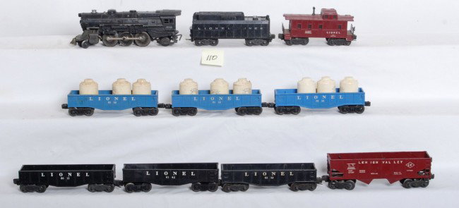 Lionel 675, 6012, 6112, 6142, 6456, 6357...: Postwar Lionel O gauge No. 675 steam loco, tender w/o whistle, 6012 gondola, four 6112 gondolas w/9 canisters, 6142 gondola, 6456 LV hopper, 6357 caboose. Please view the photographs for the best desc