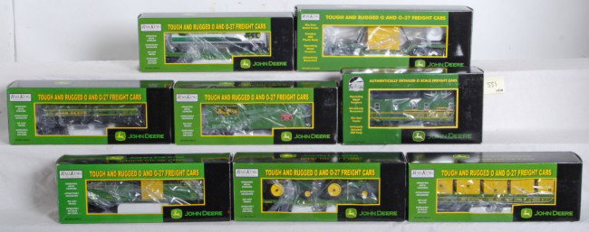 8 Railking John Deere freight cars: MTH Railking modern O Gauge John Deere freight cars. Eight cars include 91148 caboose, 7137 stock car, 7371 tank car, 7279 gondola with containers, 76147 flat with tractors, 76186 depressed center fla
