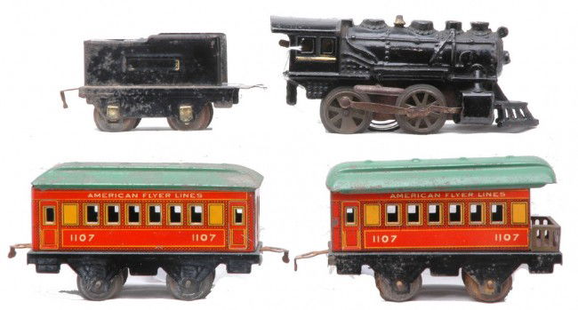AF Orange/Red Litho Pass Set Loco 3181 1107 1107: American Flyer prewar O gauge orange/red lithographed passenger set including; cast iron 0-4-0 clockwork steam loco, 3181 tender, 1107 coach and 1107 observation, both with green roofs. The tender is