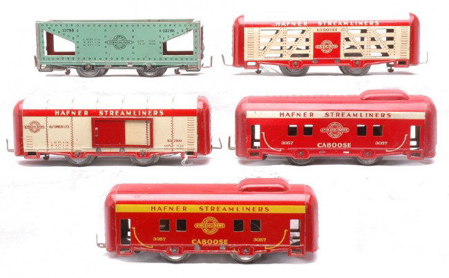 Hafner Streamliners 1350141 13789 13788 2-3057: Hafner O gauge lithographed Streamliners freight cars including; 1350141 cream/red stock car, 13789 cream/red automobile car, 13788 light green hopper and a 3057 red/cream caboose. Also included is a 