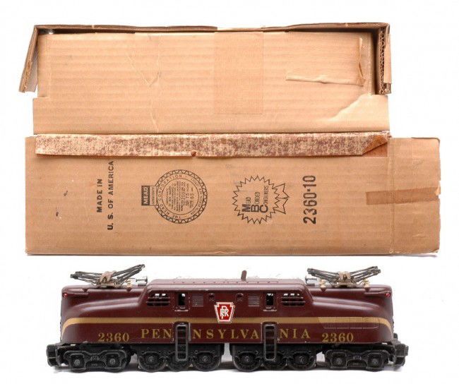Lionel 2360 Tuscan Pennsylvania GG1 w/Gold Stripe: Lionel postwar 2360 Tuscan Pennsylvania GG1 electric loco with a solid gold stripe and decaled lettering in OB with original cardboard insert. One pantograph is missing three insulators. All decals on
