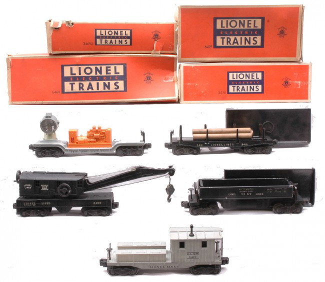 Lionel Freights 3469X 3520 6460 6419 OBs 3461: Lionel postwar freight cars including; 3469X automatic dump car with a 160 bin, 3461 operating log car with wood load and a 160 bin , 3520 operating searchlight car, 6460 black crane and 6419 D.L.&W, 