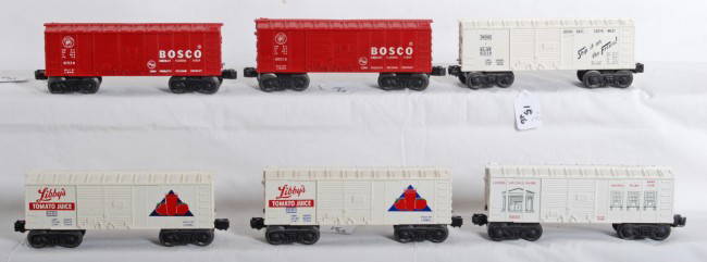 Lionel 6050, 6050, 6050, 6014, 6014, 6014 variation: Postwar Lionel O gauge boxcars, two 6050 LibbyÕs boxcars with coin slot, 6050 Savings Bank with coin slot, 6014 Frisco, and two 6014 Bosco boxcars. Trains look C6-7.