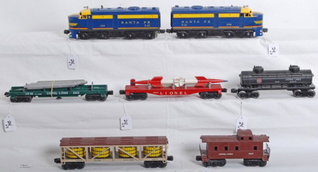 Lionel No. 208, 6475, 3362, 6823, 6465, 6017: Postwar Lionel No. 208 Santa Fe diesel Alco A units (T unit has glue repaired pilot), 6475 vat car, 3362 helium car (unrun), 6823 flatcar with rockets, 6465 Gulf tank car, and 6017 caboose. Trains loo