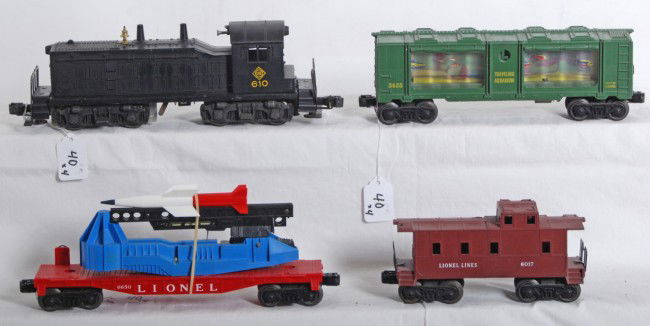 Lionel 610 Erie, 3435, 6650, 6017: Postwar Lionel O gauge No. 610 Erie NW-2 diesel switcher with 3435 aquarium car, 6650 rocket launching car, and 6017 caboose. 3435 has a cracked display window and 610 has crack at screw. Trains shoul
