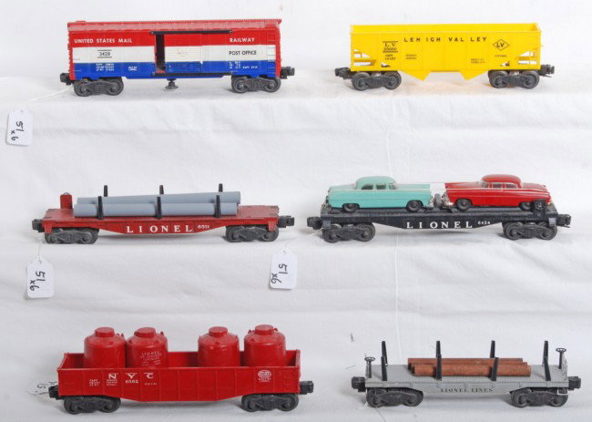 Lionel No. 3428, 6424, 6511, 6176, 6411, 6562: Postwar Lionel O gauge No. 3428 U.S. Mail RPO car, 6424 flatcar w/two original autos, 6511 pipe car w/repro pipes, 6176 LV hopper, 6411 flatcar w/three logs, and 6562 NYC gondola w/four red canisters,