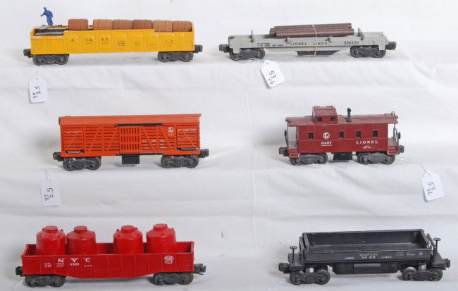 Lionel 3656, 6562, 3469, 3562-50, 3361, 6457: Postwar Lionel O gauge No. 3656 operating stock car, 6562 NYC gondola car w/two original and two repro red canisters, 3469 automatic dump car, 3562-50 A.T.S.F. barrel car, 3361 lumber flatcar w/logs,
