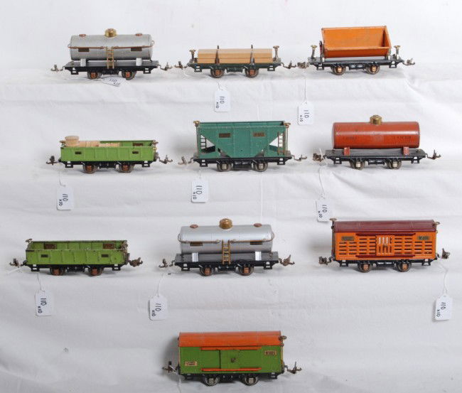 Lionel 803, 804, 805, 806, 809, 804, 902, 902, 831: Prewar Lionel O gauge freight cars, 803 hopper, two 804 tank cars, (one repainted) 805 boxcar (missing one door), 806 cattle car (repainted), 809 dump car, two 902 gondolas (one with wooden barrels an
