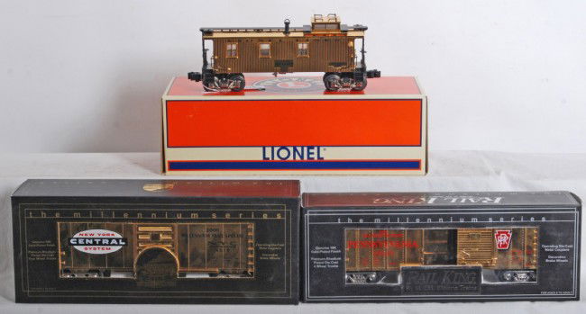 Lionel 17635 gold caboose and 2 Railking gold BC: Lionel Lines modern O Gauge 17635 gold plated caboose in OB. Caboose is high C8 with very light run time. OB has sun fading on one end. Also included two MTH Railking gold plated boxcars 93037 NYC and