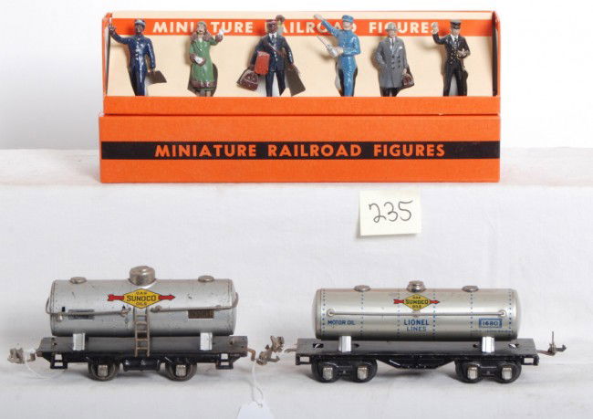 Lionel 804, 1680 Sunoco tanks, 550 railroad figure: Prewar Lionel No. 804 and No. 1680 Sunoco tanks, C6 with a little light surface rust on couplers. Modern era Lionel reproduction No. 550 miniature railroad figures in original box, C8-9.