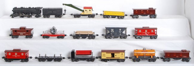 Lionel 229, 2689W with fourteen freight cars: Prewar Lionel O gauge No. 229 steam loco, 2689W whistle tender, 3652 gondola with six barrels, 2660 crane, lumber car missing platform, 3651 log car, 2682 NYC caboose, two 2657 cabooses, 1682 NYC cabo