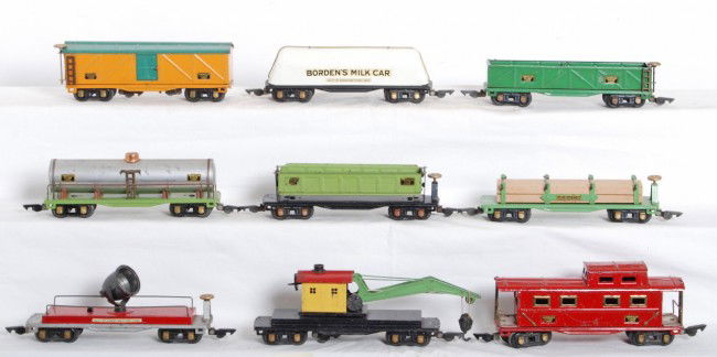 Nine American Flyer O gauge freight cars: Prewar American Flyer O gauge freight cars, BordenÕs Milk car, boxcar, searchlight car, derrick, caboose, dumpcar, flatcar with lumber load and original load restraints, tank car, and sand car, C6 ar