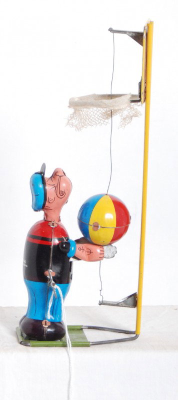 Linemar basketball shooting Popeye tin windup: Linemar basketball shooting Popeye tin windup toy. Toy looks C8-9. Mechanism winds up and functions. Ink stamped original 89 cent price on back of Popeye.