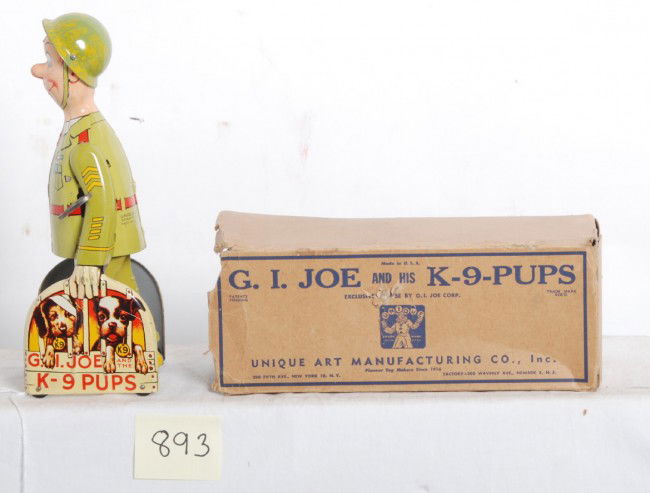Unique Art G.I. Joe and his K-9 pups toy in OB: Unique Art G.I. Joe and his K-9 pups tin wind up toy in partial original box. Toy looks C8-9. Box is missing flaps. Mechanism winds and functions properly.