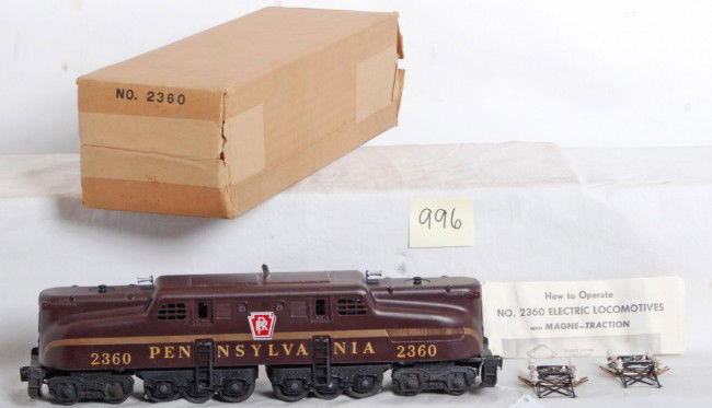 Lionel No. 2360 Pennsylvania Tuscan GG-1 in OB: Postwar Lionel O gauge No. 2360 Pennsylvania Tuscan single stripe GG-1 with heat stamped lettering, barely run C8++. Box looks very square and solid C8. Sheet of wrapping paper with pin stripes. 2360-