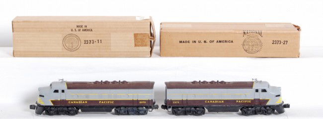 Lionel 2373P and 2373T Canadian Pacific F3 locos: Postwar Lionel O gauge No. 2373P and 2373T Canadian Pacific EMD diesel F3a units in original boxes with wrapping paper, C7-8. Trains may clean and polish to look a little better. Boxes look C9-10 in s