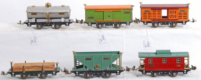 Lionel 831, 806, 803, 805, 804, 807: Prewar Lionel O gauge No. 831 flatcar w/lumber, 806 stock car, 803 hopper, 805 boxcar, 804 tank, and 807 caboose. Cars look very nice C6 area.