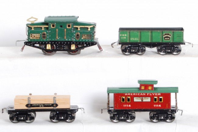 American Flyer 3110 loco, 1116, lumber, 1114: Prewar American Flyer O gauge center cab No. 3100 electric locomotive with PRR 1116 sandcar, unnumbered flatcar with lumber load (no load restraints), and 1114 caboose. Trains are clean and shiny C6 a