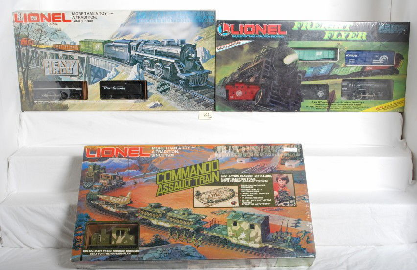 3 Lionel sealed sets 1355, 1687, and 1252: Lionel modern O Gauge sets sealed in factory cello. Three sets include 1252 Heavy Iron, 1687 Freight Flyer, and 1355 Commando Assault Train. Sets are C10, some price stickers.