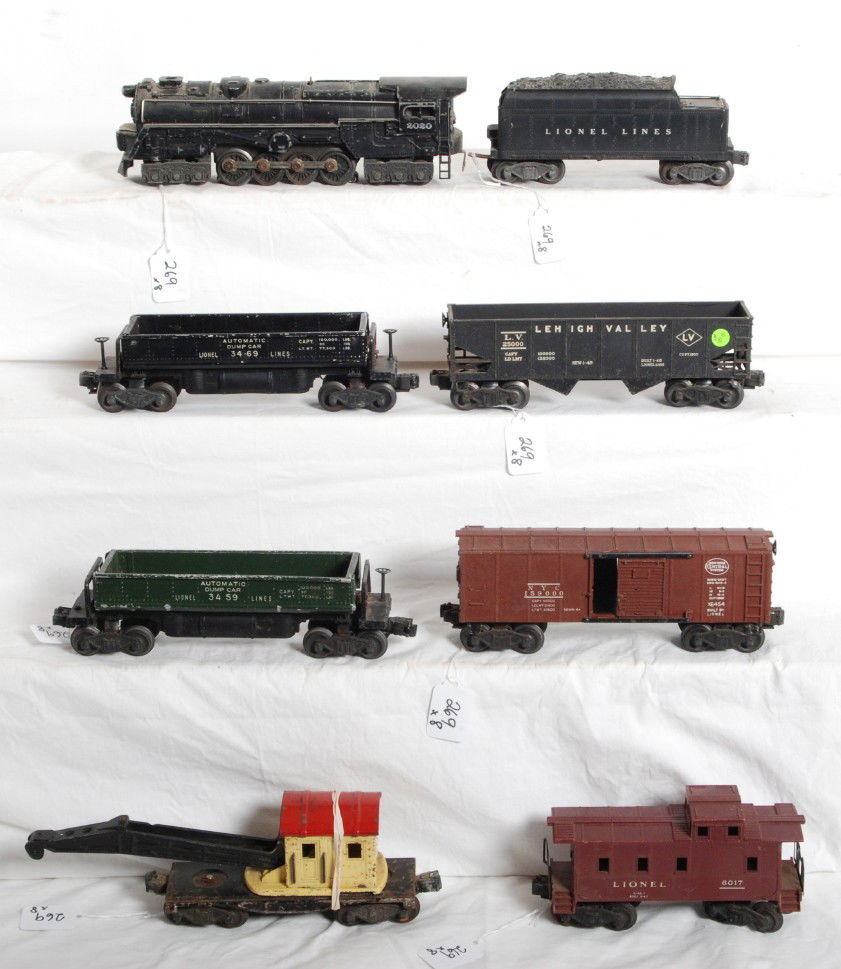 Lionel No. 2020, 2466W, 3459, 3469, 6456, 2560, 64: Postwar Lionel O gauge No. 2020 steam locomotive, 2466W tender with whistle, 3459 and 3469 dump cars, 6456 LV, 2560 derrick, X6454 New York Central boxcar, and 6017 caboose. Trains have some light sur