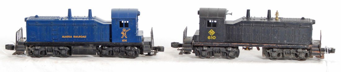 Lionel No. 610 and No. 614 NW-2 diesel switchers: Postwar Lionel O gauge No. 610 Erie and No. 614 NW-2 diesel switchers, 614 has glue marks/residue on hood. 610 has repairs at screw and 614 has screw cracks. Trains look C5-6.