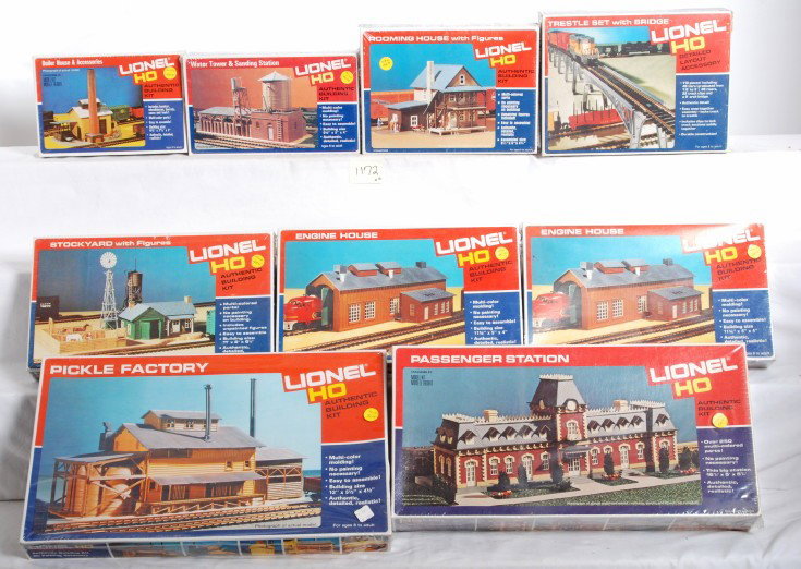 Nine Lionel HO buildings in OB, eight sealed Mint: Nine modern era Lionel HO scale building kits. 4556 boiler house, 4552 water tower and sanding station, 4557 rooming house, 4555 stockyard, two 4553 engine houses, 4554 passenger station, and 4551 pic