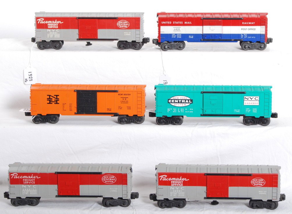 Six Lionel 6428, 6464 and 3494 boxcars: Postwar Lionel O gauge 6428 U.S. Mail, 6464-725 New Haven (missing catwalk end), 6464-900 New York Central System, 6464-125 New York Central Pacemaker (chipped step), and two 3494 New York Central Pac