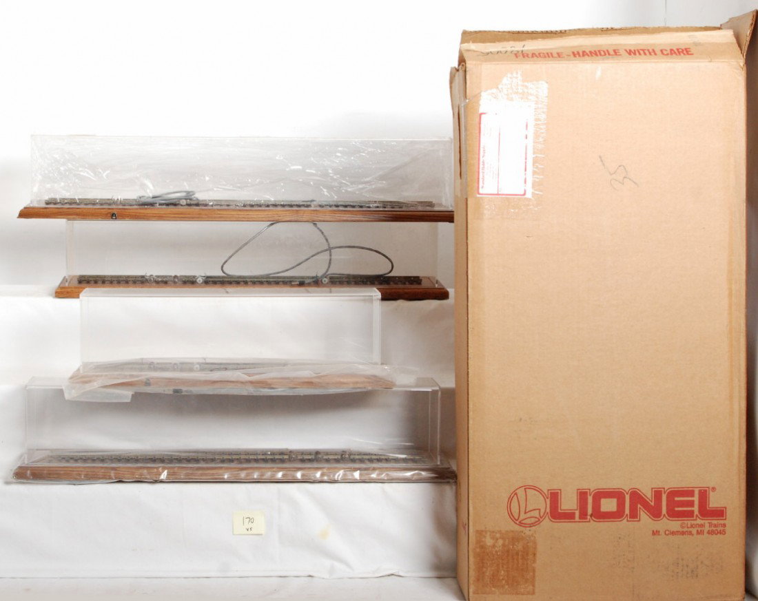 5 Lionel display cases and powered roller bases: Lionel modern O Gauge display cases and powered roller bases. Four powered roller bases include one for 3 rail Smithsonian Dreyfuss, one for Smithsonian Pennsylvania B6 switcher, one for 700E, and one