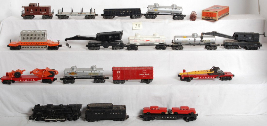 Lionel 2018, tender, 6424, 6660, 6463, 6519, 6817.: Postwar Lionel O gauge 2018 steam loco, unnumbered tender, 6424 flatcar w/original red autos, 6660 crane boom car, 6463 rocket fuel car, 6519 Allis Chalmers car, 6817 flatcar w/scraper, 2555 Sunoco ta