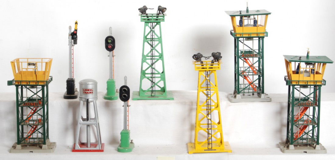 Lionel 93, 151 x2, 153, 192 x3, 395 x2: Postwar Lionel O gauge 93 water tank, two 151 automatic semaphores, 153 automatic block control signal, three 192 control towers. Two 192 are missing parts. Accessories overall look C6 area.