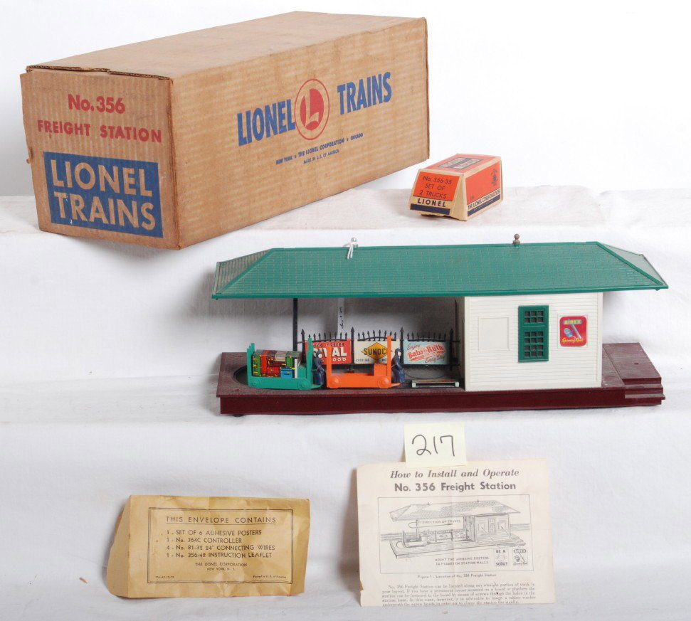 Lionel No. 356 freight station in OB w/components: Postwar Lionel O gauge No. 356 operating freight station in original box with instructions sheet, components envelope, 356-35 OB, two trucks one with luggage, and an extra fence sign. Station looks ni
