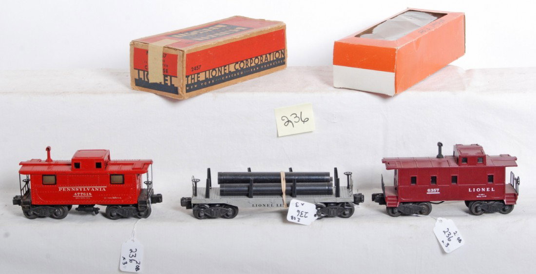 Lionel No. 6357, 2457 in OB, 2411 w/pipes: Postwar Lionel O gauge No. 6357 caboose, 2457 Pennsylvania caboose in OB missing flaps, and 2411 flatcar with original pipes, C6.