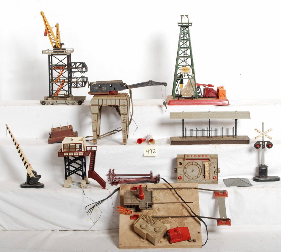 Lionel accessories 175, 455, 2820, etc.: Lionel Postwar O Gauge accessories including 455 Sunoco oil derrick, 2820 operating crane, and 175 rocket launcher. Both 2820 and 175 need rewired . Crane is missing magnet. 175 launcher has broken ha