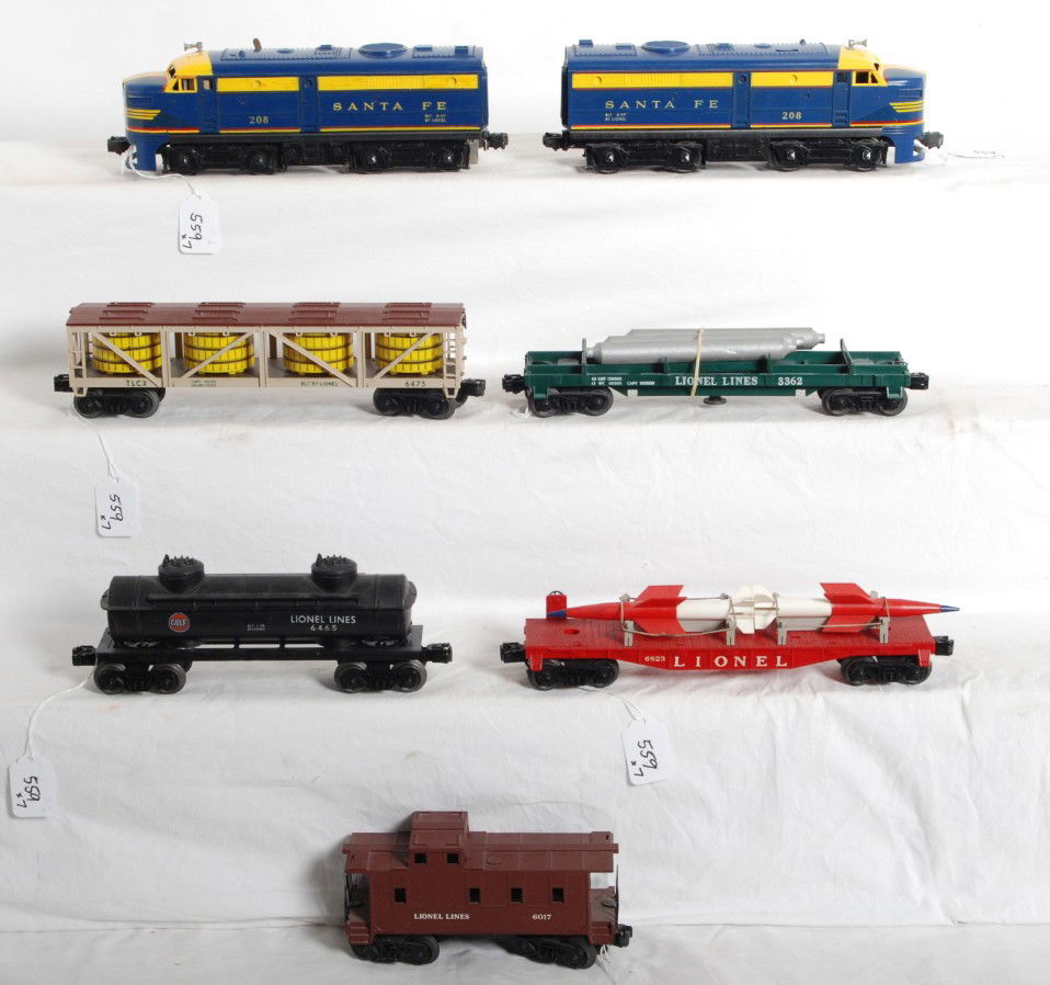 Lionel No. 208, 6475, 3362, 6823, 6465, 6017: Postwar Lionel No. 208 Santa Fe diesel Alco A units (T unit has glue repaired pilot), 6475 vat car, 3362 helium car (unrun), 6823 flatcar with rockets, 6465 Gulf tank car, and 6017 caboose. Trains loo